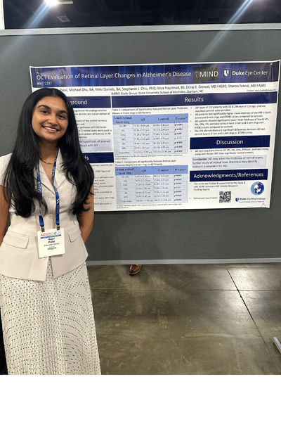 Duke trainee in front of ARVO poster