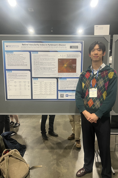 Duke trainee in front of ARVO poster