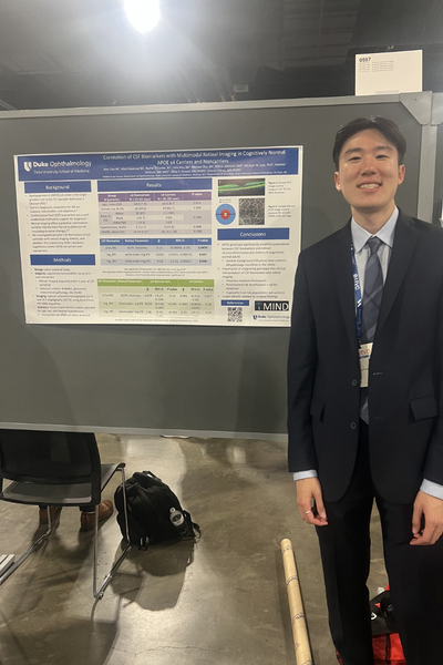 Duke trainee in front of ARVO poster