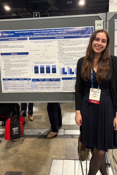 Duke trainee in front of ARVO poster