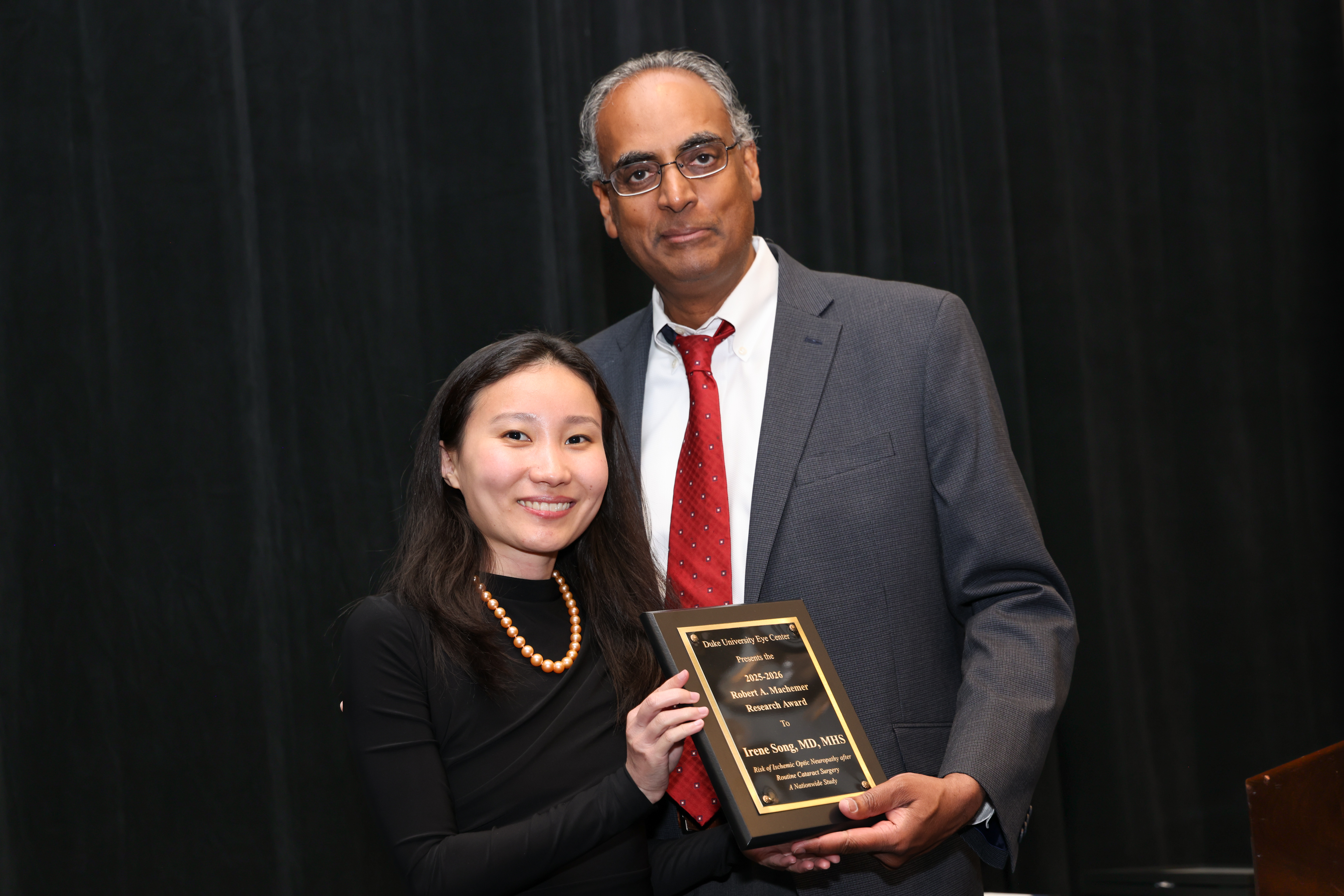 Challa with Irene Song presenting plaque for award