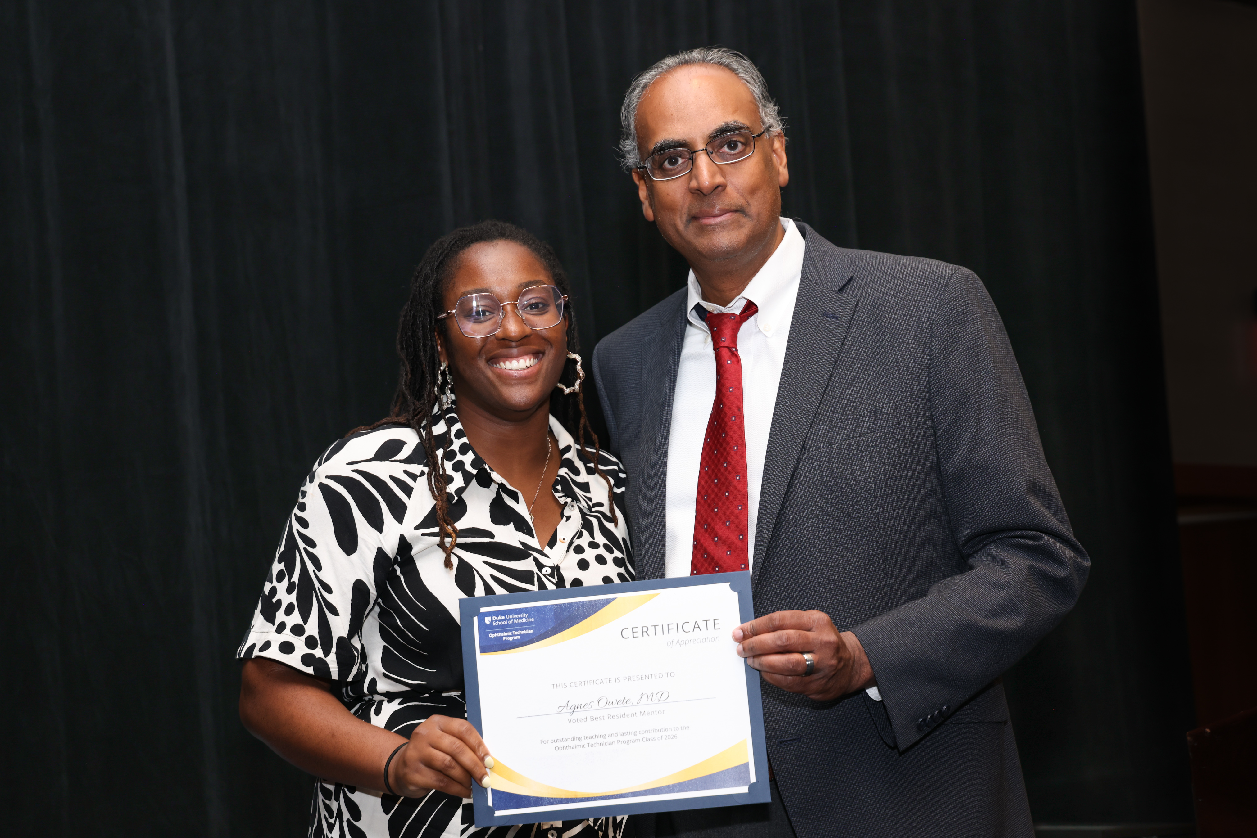 Challa with Agness  presenting award certificate 