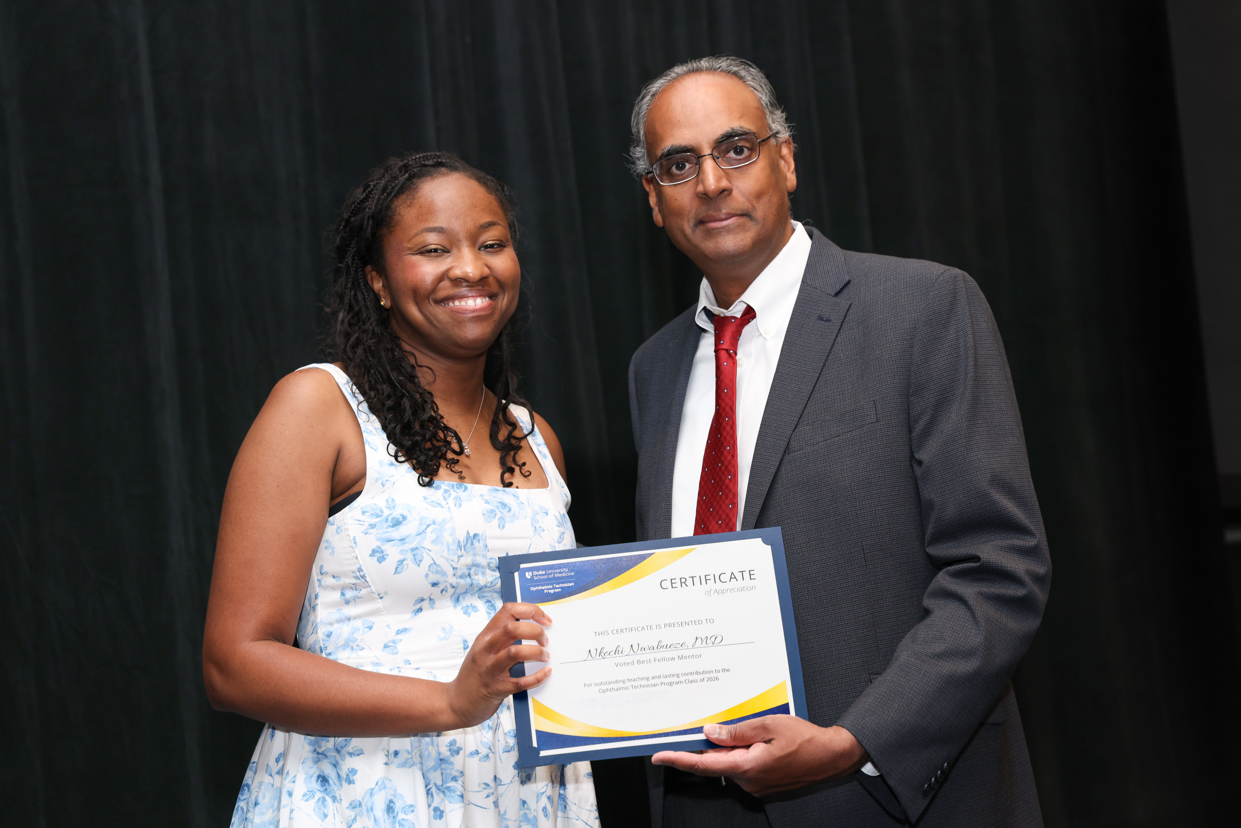 Challa with plastics fellow presenting plaque for award