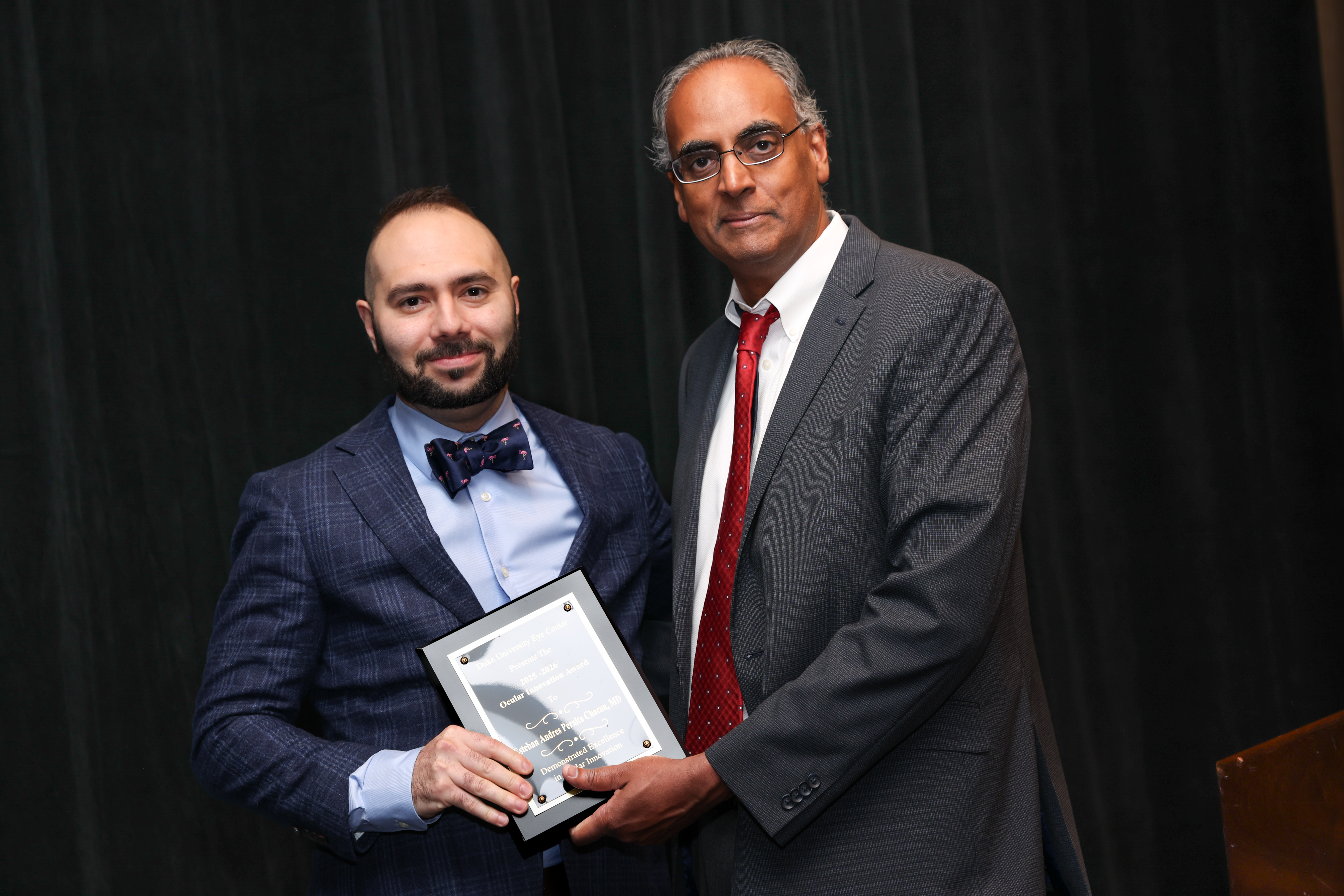 Challa with Esteban  presenting plaque for award