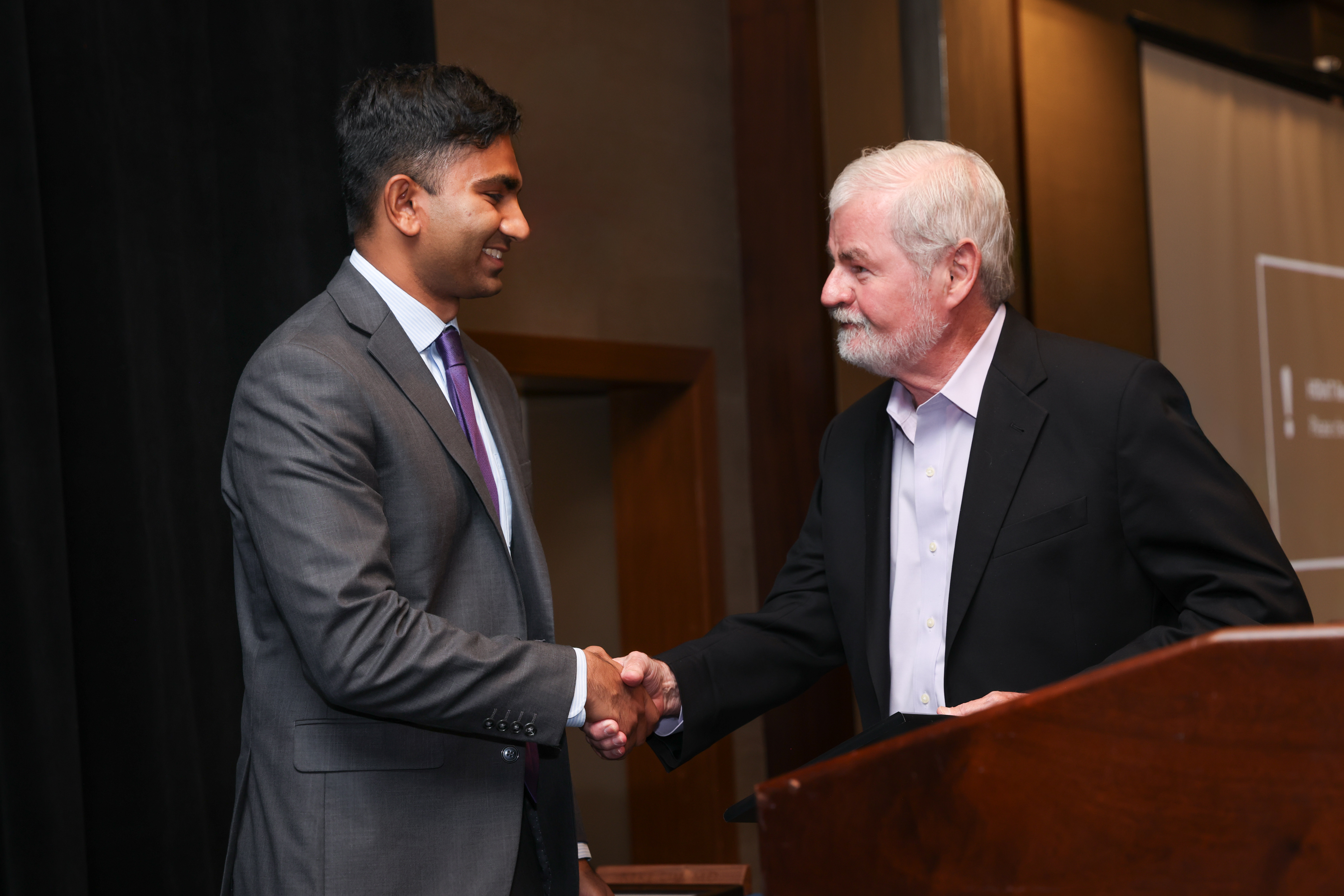 Resident shaking hands with dr. Buckley
