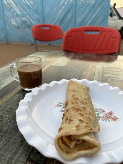 Daily breakfast of “Rolex,” or “rolled eggs,” with instant coffee,