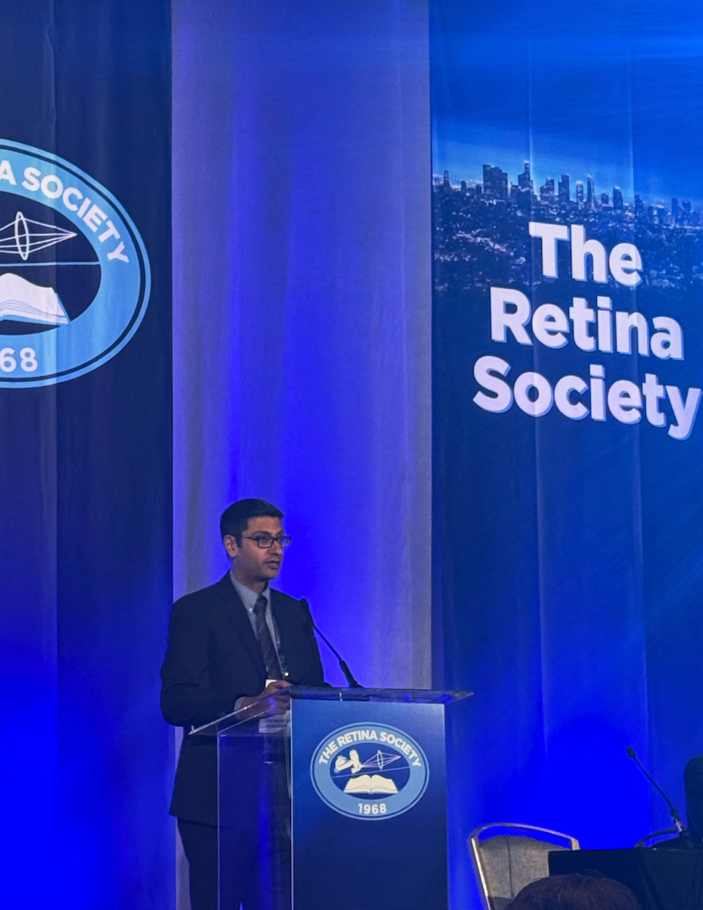 Dr. Grewal presenting at podium