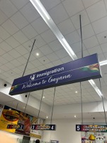 sign hanging from ceiling that says Welcome to Guyana! 