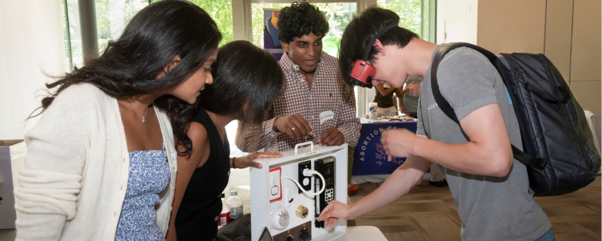 Students looking at low vision equipment