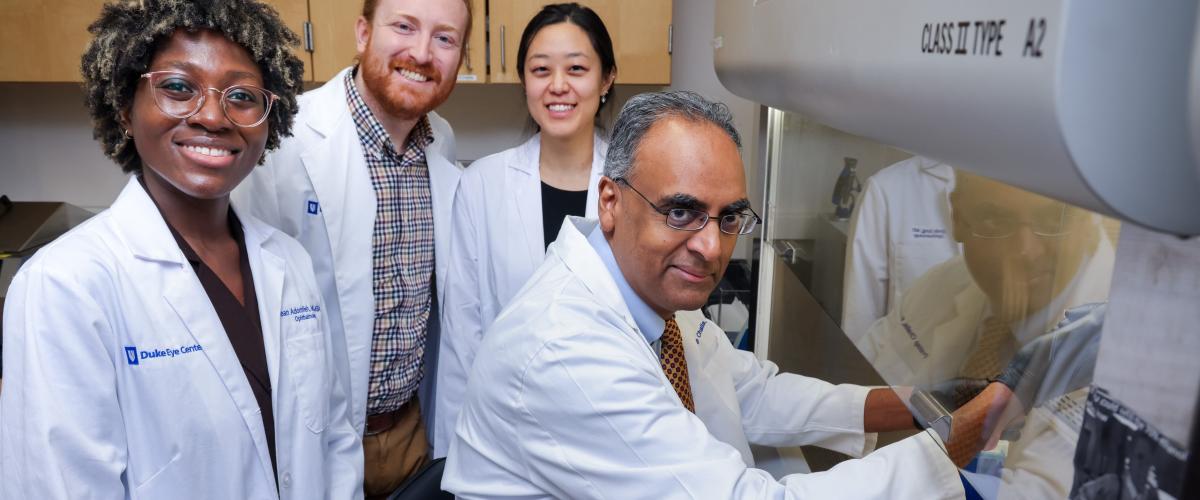 Pratap Challa with residents in research laboratory