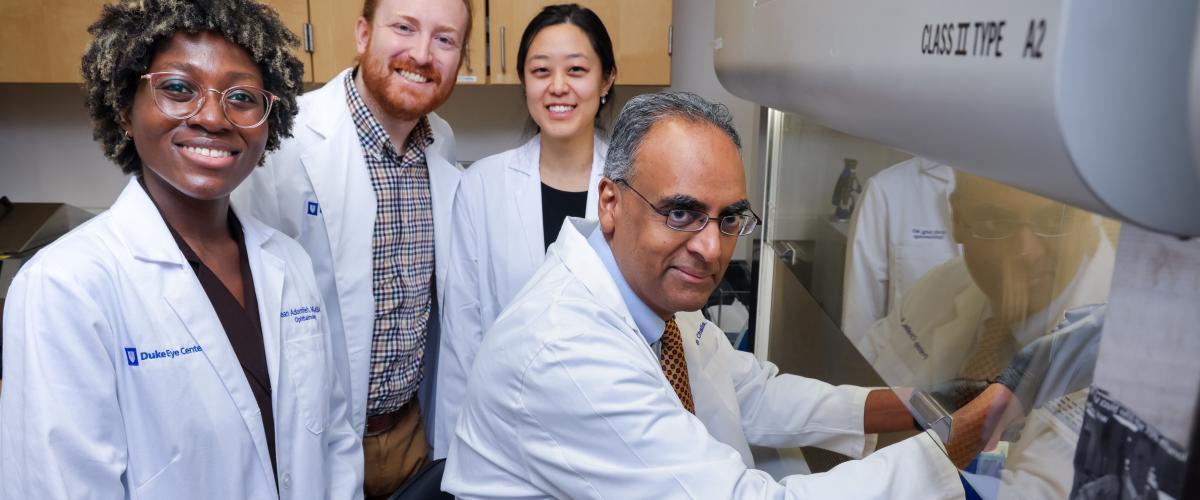 Pratap Challa with residents in research laboratory